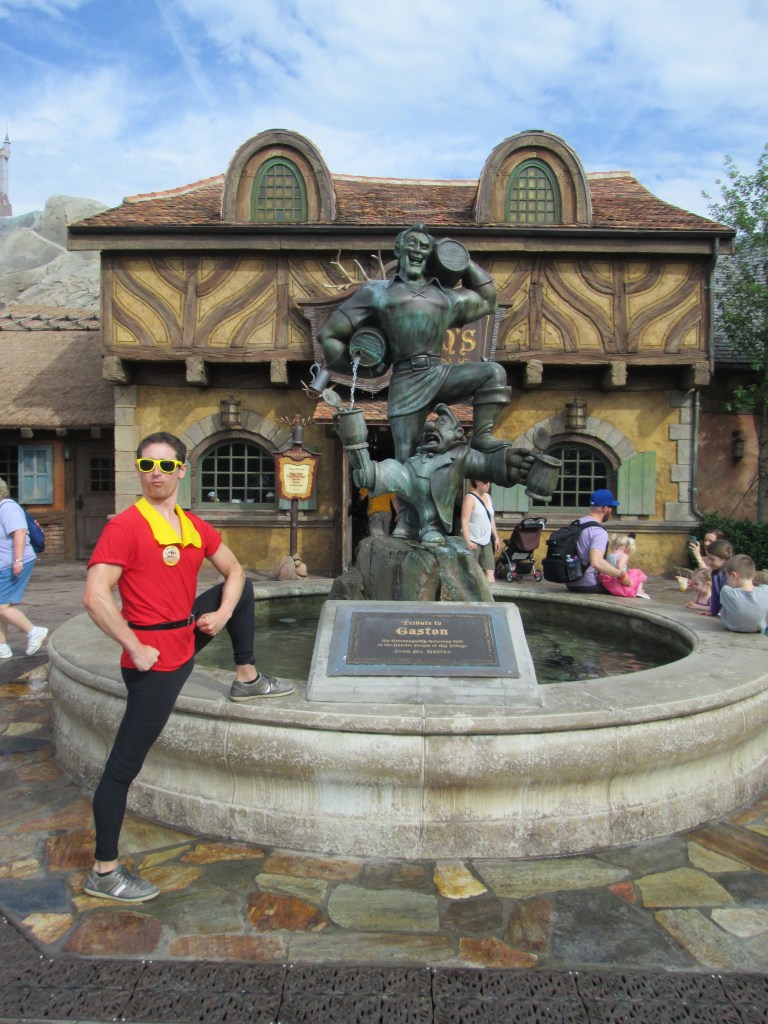 Tim as Gaston, posing with the Gaston fountain